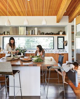 20 Best Modern Kitchen Counters - Photo 2 of 20 - In the kitchen, designer Maca Huneeus prepares lunch with her daughters Ema, 12, and Ofelia, 7. The pendants are Jonathan Adler; the island is a custom design, inspired by a 1960s Dansk tray that belonged to Huneeus’s mother. The barstools are from Blu Dot.