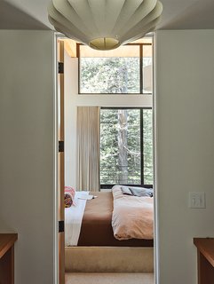 The Ski Retreat for All Seasons - Photo 7 of 10 - Maca inserted a closet-dressing room between the master bedroom and bathroom to offer more privacy to each space. She chose a vintage George Nelson lamp to lend character. 