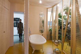 The bathroom is located at the heart of the apartment, with sliding plastic doors of varying transparency that can be moved into a number configurations.