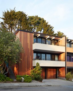 Not the Eichler Post-and-Beam Style You Know - Photo 1 of 7 - Over time, shingles had been added on the front facade. Referencing Claude Oakland's original drawings, the firm removed and replaced them with vertical grain Kayu-Batu siding. The balconies, also covered with wood shingles, received a plaster finish.