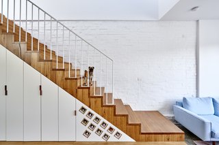 It Looks Like a Playland but This Home Works Hard - Photo 4 of 10 - Each inch is accounted for in the 1,916-square-foot home. Cabinets and clever storage for wine are tucked under the stairs. 