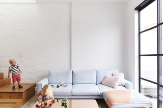 It Looks Like a Playland but This Home Works Hard - Photo 5 of 10 - Gayfer turned the home's greatest weakness, its compact size, into an advantage by encouraging interaction. Ledges, benches, and built-ins were placed tactically to promote conversation. The Errol sofa is by Jardan. 