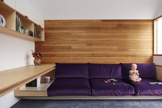 It Looks Like a Playland but This Home Works Hard - Photo 6 of 10 - Upstairs, in a living room/office, a low built-in is upholstered in Purple Velvet by Warwick Fabrics. 