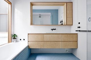 It Looks Like a Playland but This Home Works Hard - Photo 7 of 10 - Each of the home's bathrooms displays a different eye-catching shade of tile from Inax, such as baby blue. 