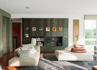 The fireplace wall, a Resolution: 4 signature, is made of 14-gauge hot-rolled steel panels with storage components in one-eighth welded steel. On one side is a pivoting privacy panel that allows the guest wing to be closed off. Art attaches to the metal with magnets. 