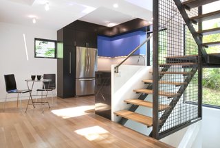 Inside, where the dining and living spaces were reconfigured, the vibrant colors continue with smaller accents like the azure cabinetry. 