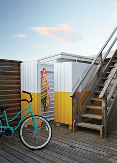How a Smart Interior Design Saved This House - Photo 3 of 9 - The wood screen concealing the outdoor shower was painted yellow and white, matching the color scheme in the guest bathroom.