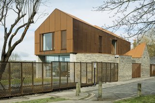 Along the road, the exterior walls are covered with ash-glazed Sussex brickwork, which "gives a softer texture and more intimate scale to the street," Rendel says. 