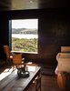 Modern home with Living Room and Chair. In the living room, an antique farm table surrounded by Charlotte Perriand chairs adds an organic element to the streamlined space. Photo of Examples of Rustic Modern Done Right