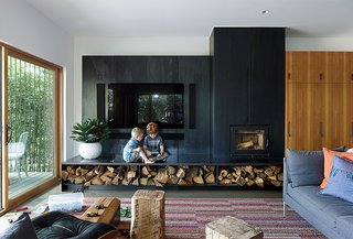 These Modern Parents Show How Invaluable Technology Can Be - Photo 4 of 12 - Cash and Rock are shown here in front of a blackened steel "fireplace wall" that was designed by Hufft Projects. Matthew explains how he’s learned to design things that are durable and safe. He continues, "You never realize how destructive kids are until you have them. I’m continuously learning from them and how they interact within architecture." 