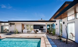This modern residence by designer Soheil Nakhshab incorporates elements of the surrounding landscape through touches of stone, wood, and iron.