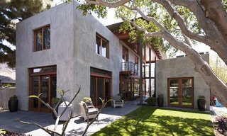 A custom wood screen frames a material-rich private beach escape in Crown Point.