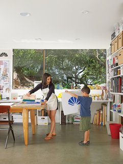 Verda Alexander and her son, Apolo, collaborate on a project in their first-floor studio. 