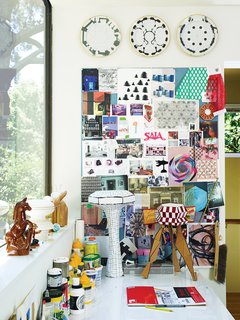 Inspiration crowds Alexander’s studio desk. 