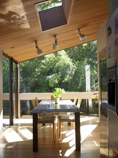 The family is never far from the outdoors, as this lush view from the dining room attests. 