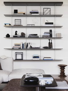 The sitting area features Jean Nouvel's Graduate shelf for Molteni&C and walnut stool by Charles and Ray Eames.