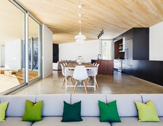 This Snowbound Pad Will Actually Make You Miss Winter - Photo 3 of 3 - A sober material palette, including polished concrete radiant floors and black ceramic tiles, defines the interiors. The cedar ceilings extend outdoors for continuity. 