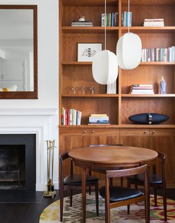 The dining set was designed by midcentury Danish deisgner Hans Olsen. It's illuminated by a duo of Mori Gourd pendants, also by Rich Brilliant Willing.
