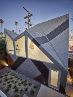 Concerned that studio was too big compared to other homes in the neighborhood, the 1,060 square-foot structure references the dazzle pattern, a camouflage technique used by WWII battleships. Monti was inspired by the way the pattern "helps break down the scale of a large ship." Modal Design choose the zinc colors that fit with the neighborhood. "From afar and at certain angels, it is hard to see where one starts and one ends." says Monti. 