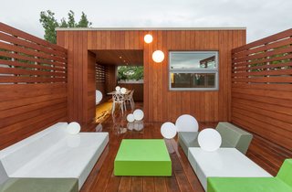 Smart & Green Ball lamps illuminate the penthouse deck, which is outfitted with low-slung Matrass lounge furniture from Quinze & Milan. All of the exterior spaces are lined in rich garapa hardwood.