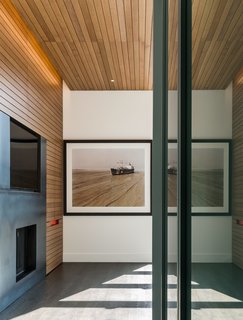 When closed, the miniature workspace vanishes into the detailed white oak millwork by KWI Cabinetry.