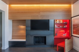 In the office, doors slide back and a chair pulls out to reveal a custom built-in desk.
