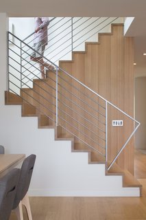 The materials are limited to white millwork and white oak. "When we come home, we want something serene," Broughton says. 