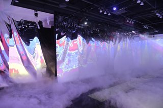 Titled HISS MISSY, the immersive experience, which combines digital video projections, a lighted runway, and fog machine, was chosen for its interactive element. And, in the age of social media, it's the perfect place to snap and share a selfie, the curators say. 