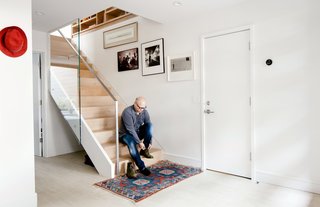 A glass panel was placed along the stair banister to create a transparent pathway for light to travel down from the second-floor skylight. Otherwise, Azevedo left the staircase mostly untouched, a rare exception in her to-the-studs renovation. 