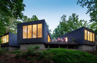 A Dwell Favorite: Relaxing Along the River - Photo 1 of 3 - Desiring a home in a natural setting for their three sons, ages 5, 9, and 10, architects Katie and Danny MacNelly built a three-volume residence near Virginia’s James River. With a focus on outdoor social spaces, Katie likens the overall program to "loose coals around a campfire."