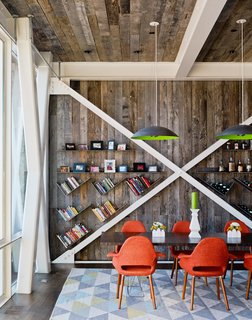 The interior nods to its host structure’s heritage with some walls and the ceiling clad in reclaimed oak from a Kentucky farmhouse. Custom pendants by Mickus Projects hang above a Curzon table from Modloft.