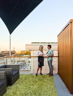 The cable railing around the perimeter of the deck is capped with a banister made of reclaimed river cypress. 