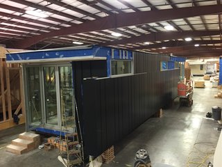 On the width side of the home is a full wall of accordion doors that open to the outdoors.