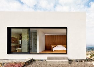 Inside the home, each volume tonally matches its exterior. The stucco-clad upper floor, which contains mostly private quarters, prominently features white oak casework. 