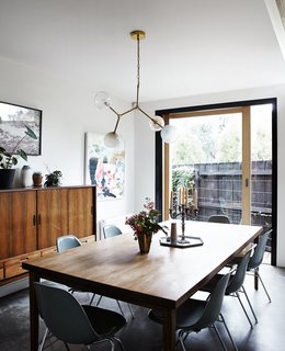 A Y chandelier by Douglas and Bec hangs above a vintage table and chairs. 