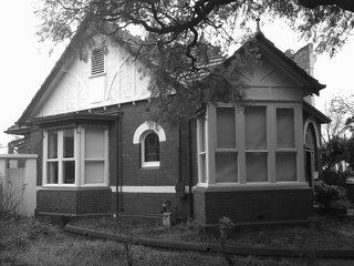 With a fresh coat of black Dulux paint on the trim, the front facade retains its original early-20th-century appeal.