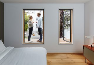 This helps tie the overall design of the house together," says Jeffries. The windows of the master bedroom—which features a Dann Sideboard by TemaHome—open to reveal a mahogany hardwood deck.