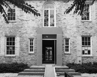 What’s the Twist Behind This Home’s Sinuous Staircase? Ordinary Plywood - Photo 3 of 14 - Opacity defines the north facade, composed mostly of brick.