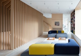 What’s the Twist Behind This Home’s Sinuous Staircase? Ordinary Plywood - Photo 13 of 14 - An expanse of windows along the transparent, glass-filled southern facade keeps the main living area well-lit during the day; a grid of Buschfeld Shop-V 100 lights illuminates it by night.