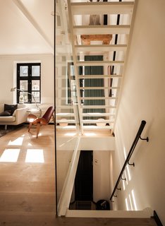 "From the day we got our house, I knew exactly how I wanted it done," says Mia Dalgas, who led the renovation of her family’s 1880s home in Copenhagen’s Potato Rows district. One of the biggest transformations was the addition of a glass-enclosed lacquered wood staircase.