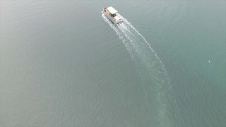 Captured by drone, this photograph shows the prefabricated elements of the Brown house being transported to the build site on French Island by barge. 