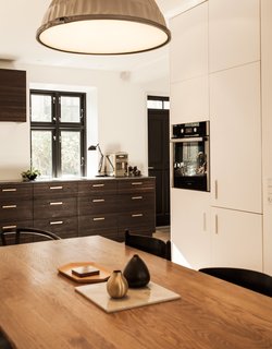 Lisette Bernhoft of Design by Us planned the kitchen. The smoked oak cabinets are topped with lava stone. The pulls are brass. 