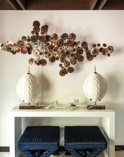 One Couple's Imagination Goes Wild at a 1967 Weekend Retreat - Photo 4 of 12 - Nearby, the Lacquer Console Table holds a pair of Ceramic Tortoise Shell lamps and conceals a Double X bench, also by the designer (below). The brass Raindrops wall sculpture, a reissue of a midcentury metalwork by C. Jeré Studio, is from JA Finds, Adler’s curatorial venture. 