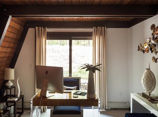 One Couple's Imagination Goes Wild at a 1967 Weekend Retreat - Photo 5 of 12 - Damen, who is the chief technology officer for Jonathan Adler’s eponymous studio, filled the house with the designer’s work, like the Lucite-and-mappa-wood Bond desk and the Regent armchair in the shared office.
