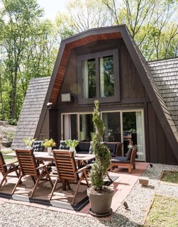 One Couple's Imagination Goes Wild at a 1967 Weekend Retreat - Photo 9 of 12 - The patio is equipped with IKEA furniture; the previous residents chose the sliders and windows, which are by Sierra Pacific