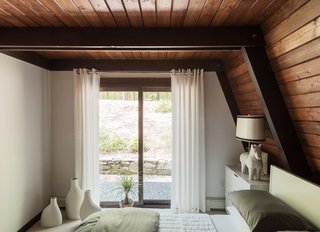 One Couple's Imagination Goes Wild at a 1967 Weekend Retreat - Photo 10 of 12 - The guest bedrooms feature lighting by Jonathan Adler, including a Horse table lamp in the downstairs unit and an Antwerp pendant upstairs. 