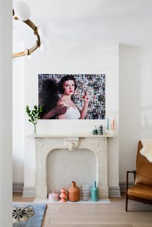 Modern Becomes Eclectic in This Renovated Brooklyn Townhouse - Photo 3 of 13 - An original marble fireplace now acts as a display area for a colorful collection of vases from CB2; a geometric floral Medina Tibetan carpet by Madeline Weinrib adds a touch of pattern to the room.