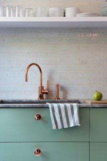 Modern Becomes Eclectic in This Renovated Brooklyn Townhouse - Photo 6 of 13 - Lyons and Brill designed several custom touches, like the copper-plated knobs they installed on the Sektion kitchen cabinetry from IKEA, painted in Farrow & Ball’s muted Breakfast Room Green.