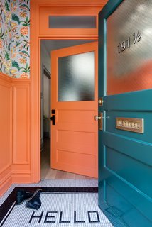Modern Becomes Eclectic in This Renovated Brooklyn Townhouse - Photo 8 of 13 - The vestibule is painted in Benjamin Moore’s coral-hued Hot Spice and covered in a Cuban-inspired floral wallpaper by fashion designer Matthew Williamson for Osborne & Little.