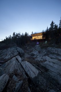 House of the Week: Whale Watching at This Edgy Abode - Photo 2 of 2 - Visitors can keep lookout for the St. Lawrence River’s resident marine mammals, which include Beluga and Sperm whales, from a pair of Adirondack chairs. 